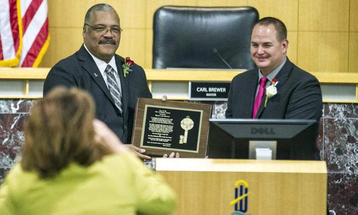 Former Wichita Mayor Carl Brewer, left, poses with Vice Mayor Jeff Blubaugh after being presented with the key to the city during Tuesday’s Wichita City Council meeting. (April 14, 2015)