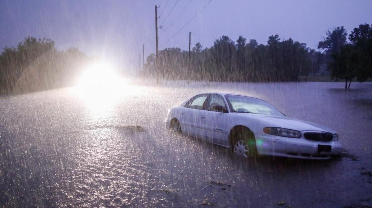 A car sits in a ditch near Broadway and 103rd St. South during flooding last year.