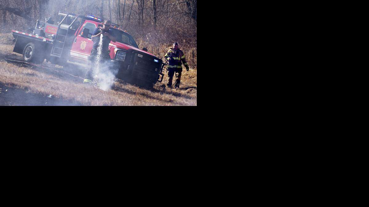
Sedgwick County firefighters douse grass fires near K-42 in February. The department wants to fill six open positions for safety and to improve service, fire officials said. 
