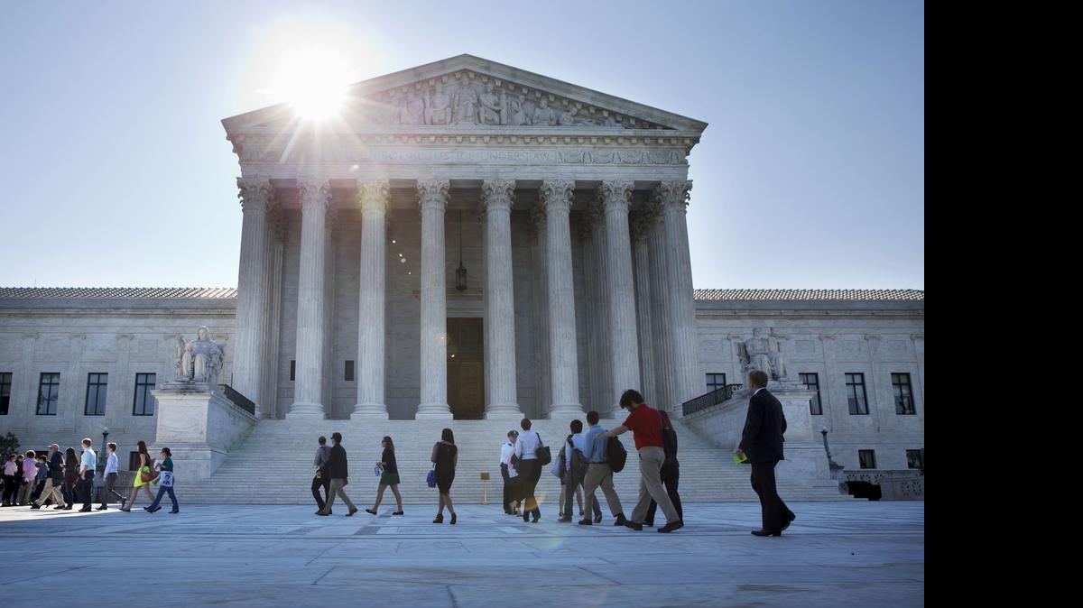 
People enter the Supreme Court in Washington, Monday June 29, 2015. The Supreme Court was meeting for the final time until the fall to decide three remaining cases and add some new ones for the term that starts in October. The three remaining cases that are expected to be decided Monday raise important questions about a controversial drug that was implicated in botched executions, state efforts to reduce partisan influence in congressional redistricting and costly Environmental Protection Agency limits on the emission of mercury and other toxic pollutants from power plants. (AP Photo/Jacquelyn Martin) 
