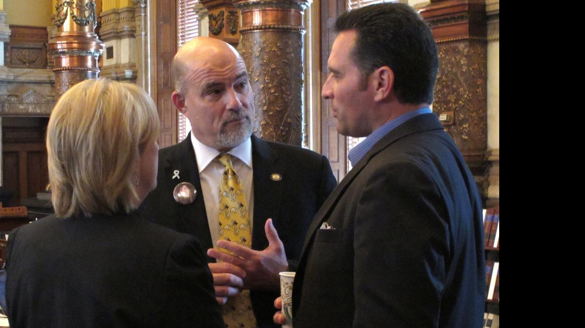 
Kansas state Sen. Greg Smith, center, R-Overland Park, confers with Sens. Mary Pilcher-Cook, R-Shawnee, and Ty Masterson, R-Andover, during the chamber's debate on a plan for raising taxes to close a budget shortfall, Sunday, June 7, 2015, at the Statehouse in Topeka, Kan. The plan raises sales and cigarette taxes. (AP Photo/John Hanna) 
