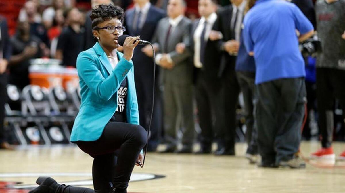 This photo of Denasia Lawrence singing the national anthem at a Miami Heat game was used in a profane meme on Facebook. Kansas Rep. Joe Seiwert replied to the meme that Lawrence should “go home” to another country.