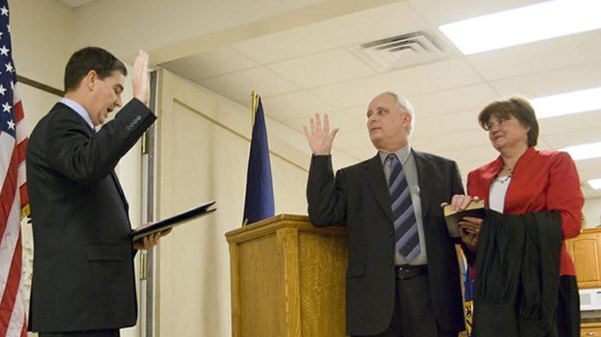 Michael Gibbens stood next to his wife, Nancy, as he was sworn in as First District Court judge by District Chief Judge David King in 2008.