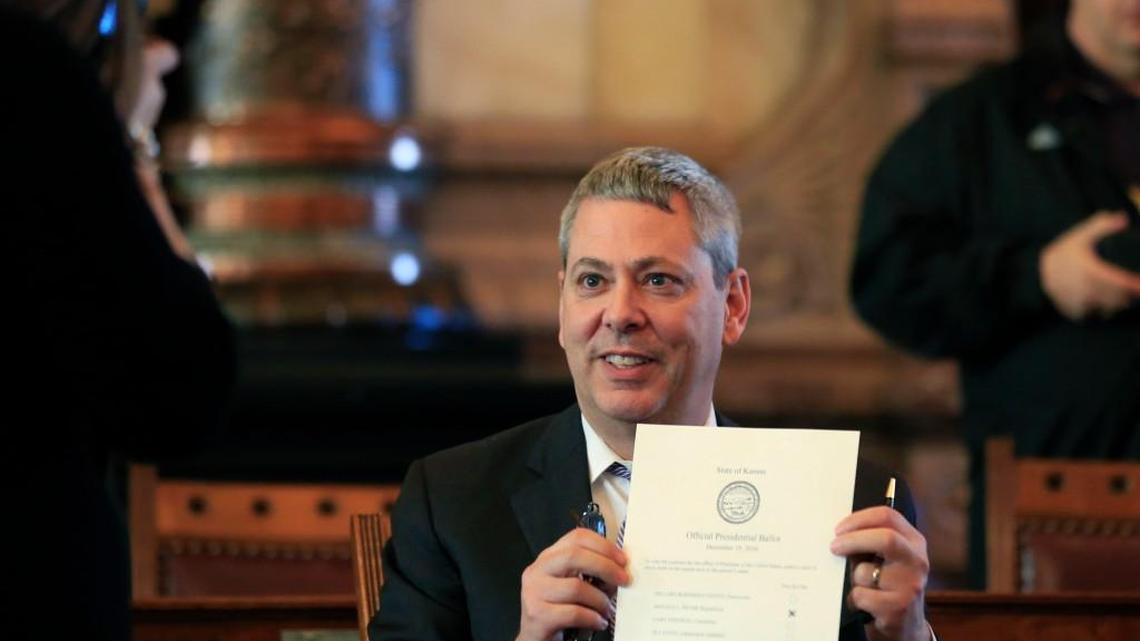 Electoral College elector Clay Barker holds his ballot for a photo during a meeting in the Senate chamber of the Kansas Statehouse in Topeka on Monday. (Dec. 19, 2016)