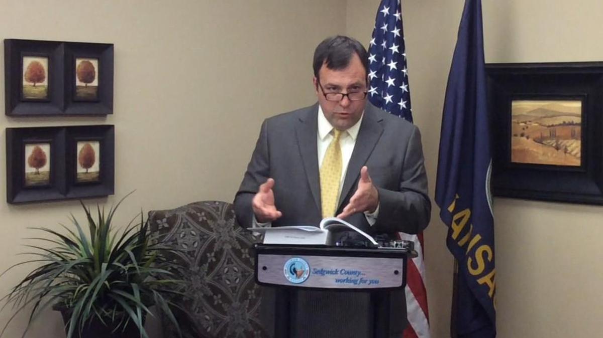Sedgwick County District Attorney Marc Bennett speaks to reporters about his decision on the proposed recall of Commission Chairman Richard Ranzau.