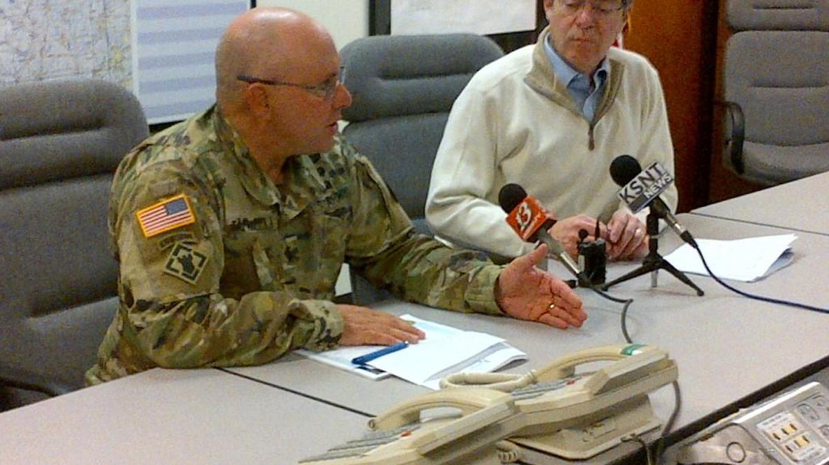 Gov. Sam Brownback, right, and Kansas National Guard Adjutant Gen. Lee Tafanelli say the state will receive a federal grant to reimburse fire departments for the cost of fighting the fires.