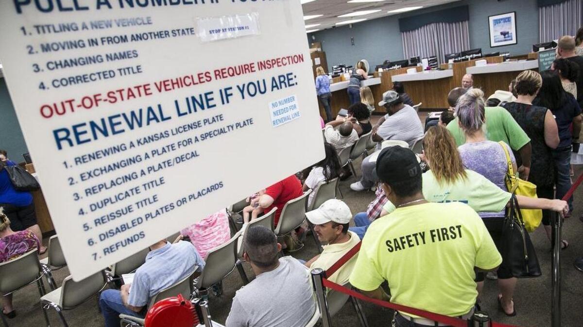 Vehicle owners wait in line at the Sedgwick County Tag Office on West Murdock last summer. (Aug. 31, 2015)