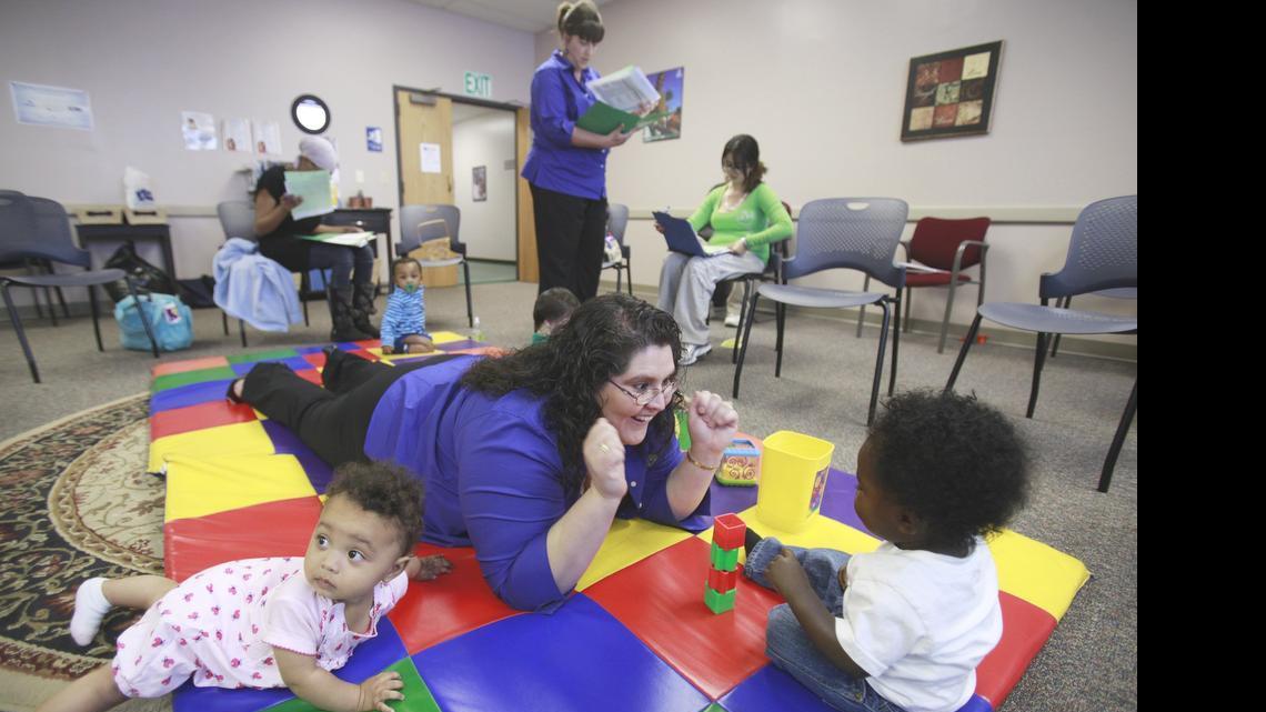 
Christina Rodriquez, an RNBSM, plays with babies during a monthly meeting of a parenting group in the Sedgwick County Healthy Babies program. (2011)
