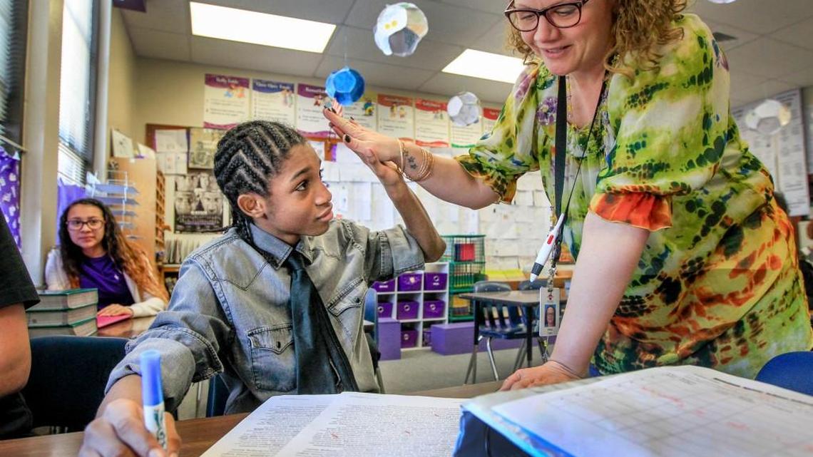 Hamilton Middle School eighth-grader Sundale Buggs works with his teacher Elissa Frank in February. A plan being considered by a House committee would add about $750 million in education funding over the next five years.