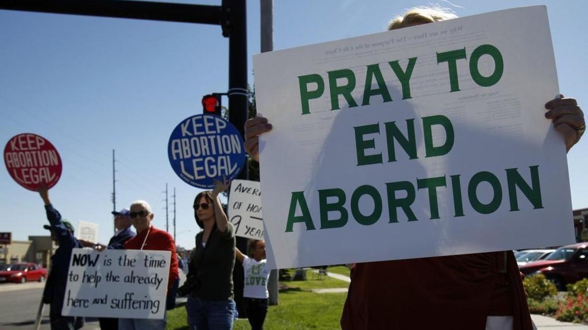 Abortion opponents and abortion-rights supporters engage in a public protest at Central and Rock Road in Wichita in this file photo.