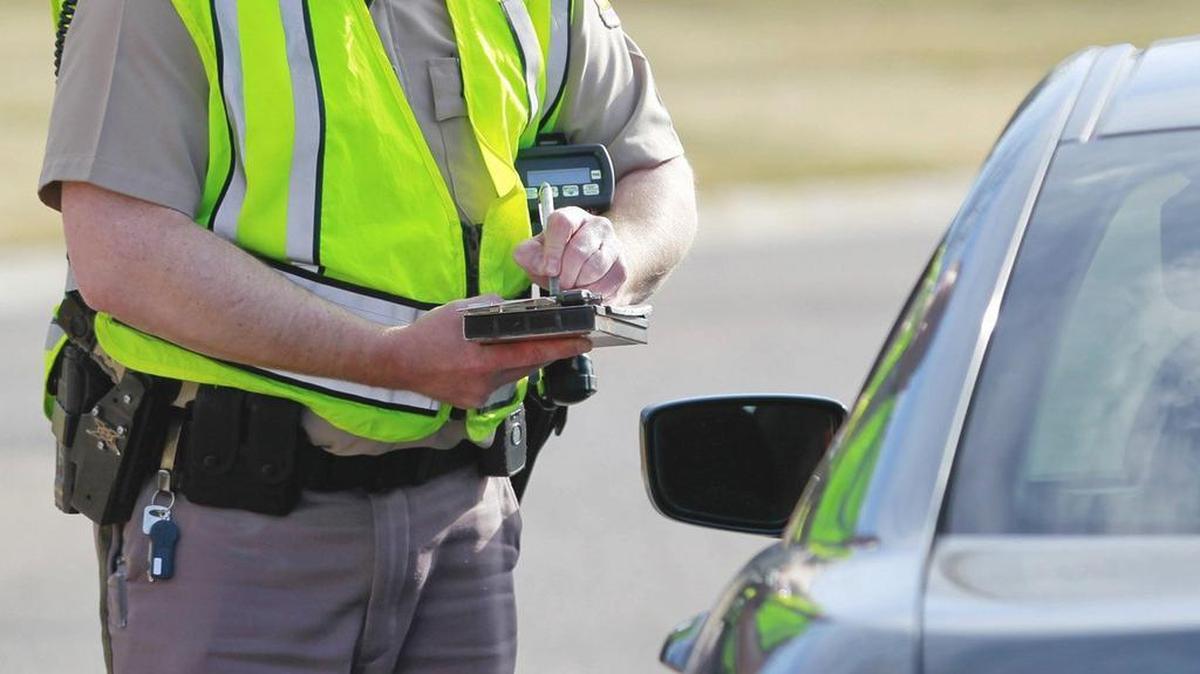 A police officer writes a ticket in this file photo.