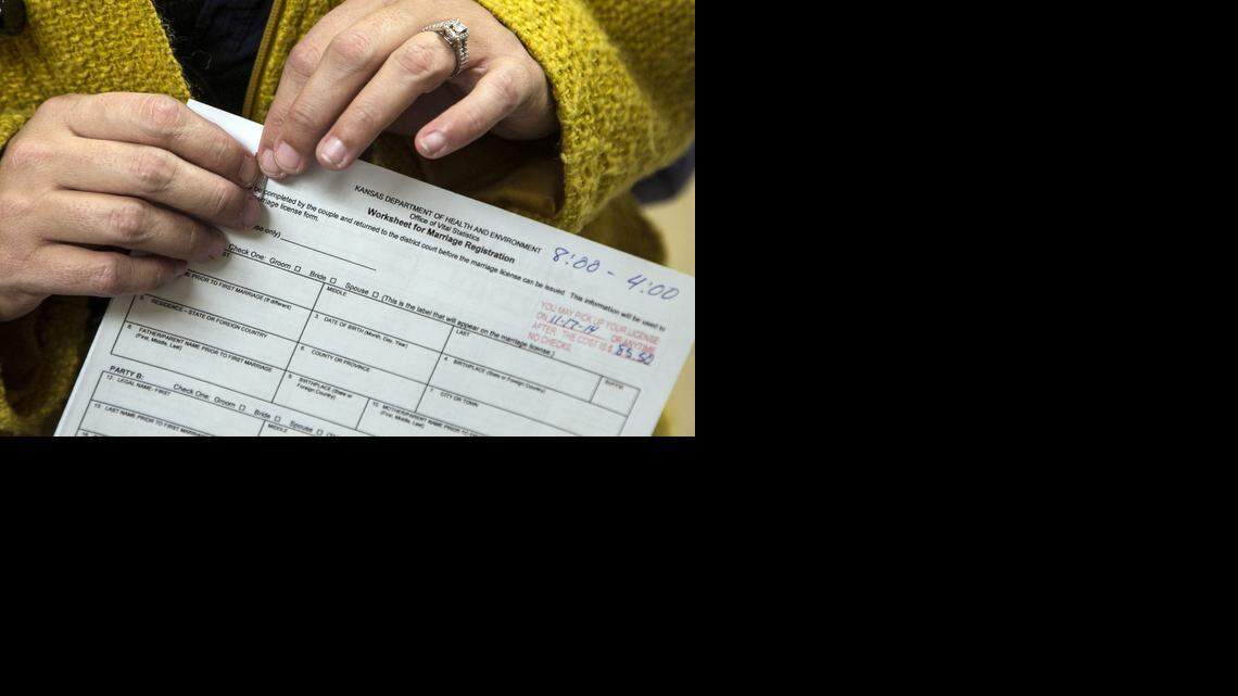 
Gay residents pick up applications for marriage licenses at the Sedgwick County Courthouse on Thursday after the Supreme Court lifted the hold on same-sex marriage in Kansas on Wednesday. (Nov. 13, 2014) 
