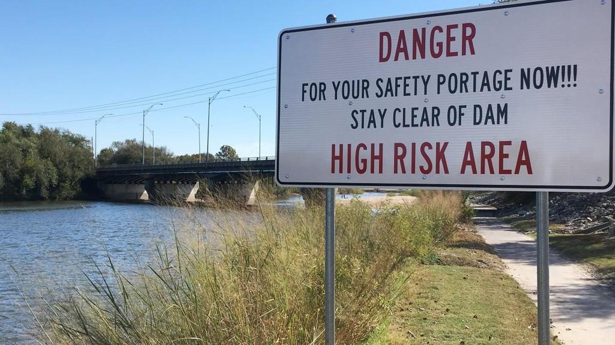 The city of Wichita this week installed new warning signs at the 21st Street dam. Brian Bergkamp drowned at the dam on July 9 while kayaking on the Arkansas River, when the water was higher. (Oct. 21, 2016)
