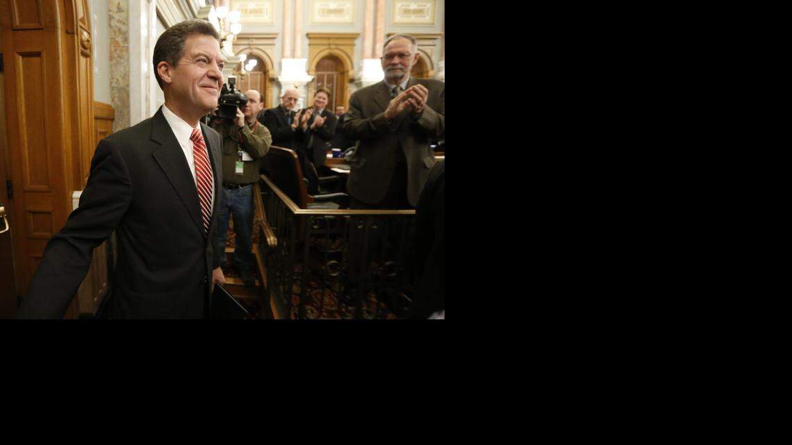 
Kansas Gov. Sam Brownback walks into the House of Representatives on Thursday to deliver his annual State of the State address. (Jan. 15, 2015)
