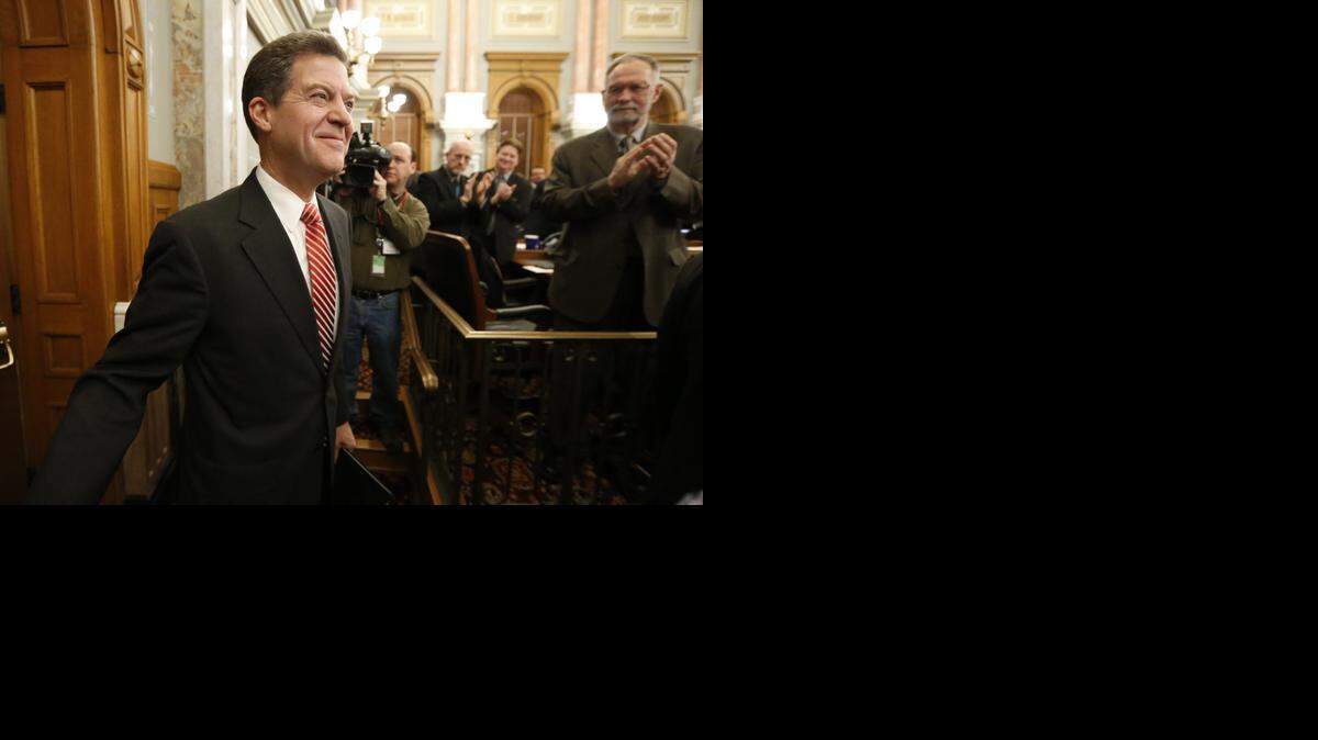 
Kansas Gov. Sam Brownback walks into the House of Representatives on Thursday to deliver his annual State of the State address. (Jan. 15, 2015)
