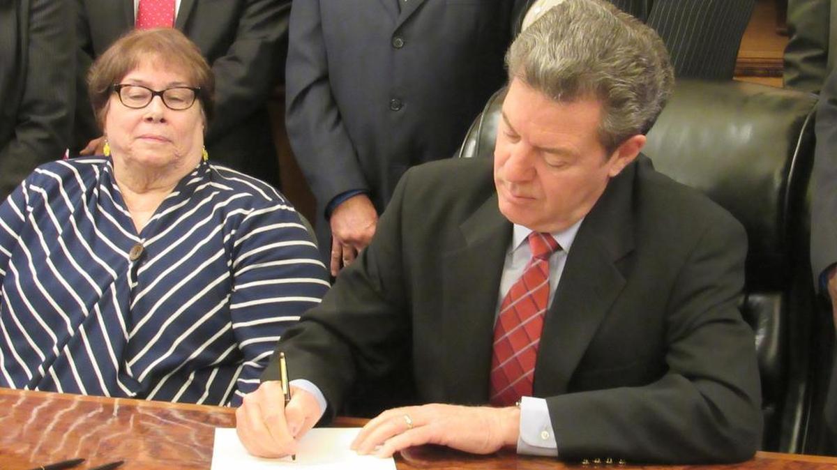 Gov. Sam Brownback signs a bill Monday that will reduce the number of months families can receive Temporary Assistance for Needy Families. Brownback said the tighter deadlines will encourage people to re-enter the workforce sooner. (May 16, 2016)