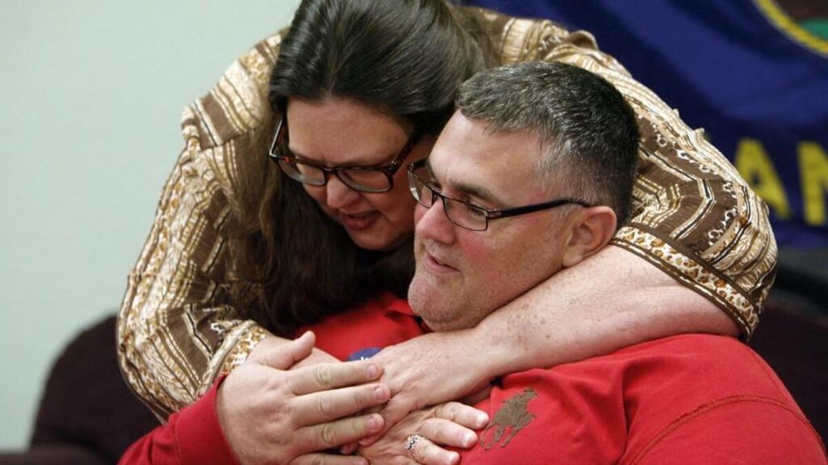 Patsy Terrell embraces Jon Powell near the conclusion of the “Vote Yes for Fairness” watch party in 2012 in Hutchinson.