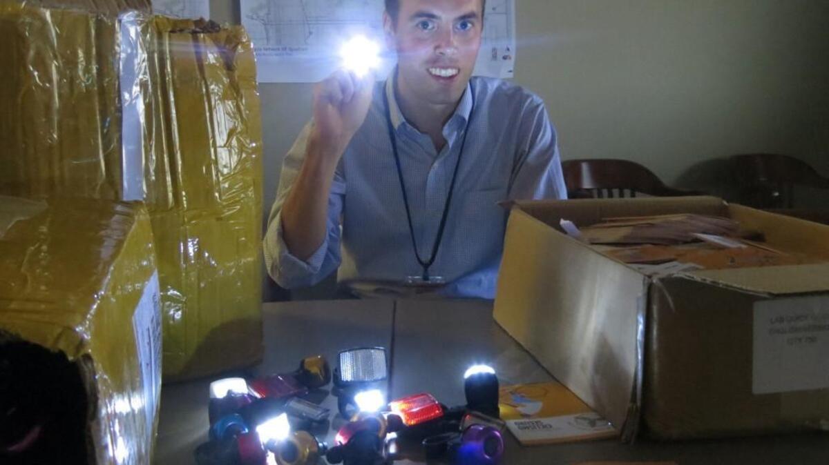 
Wichita planner Scott Wadle holds one of the 1,200 bike headlights the city will be distributing for free to the public. The distribution will also include reflectors, bike bells and safety brochures.
