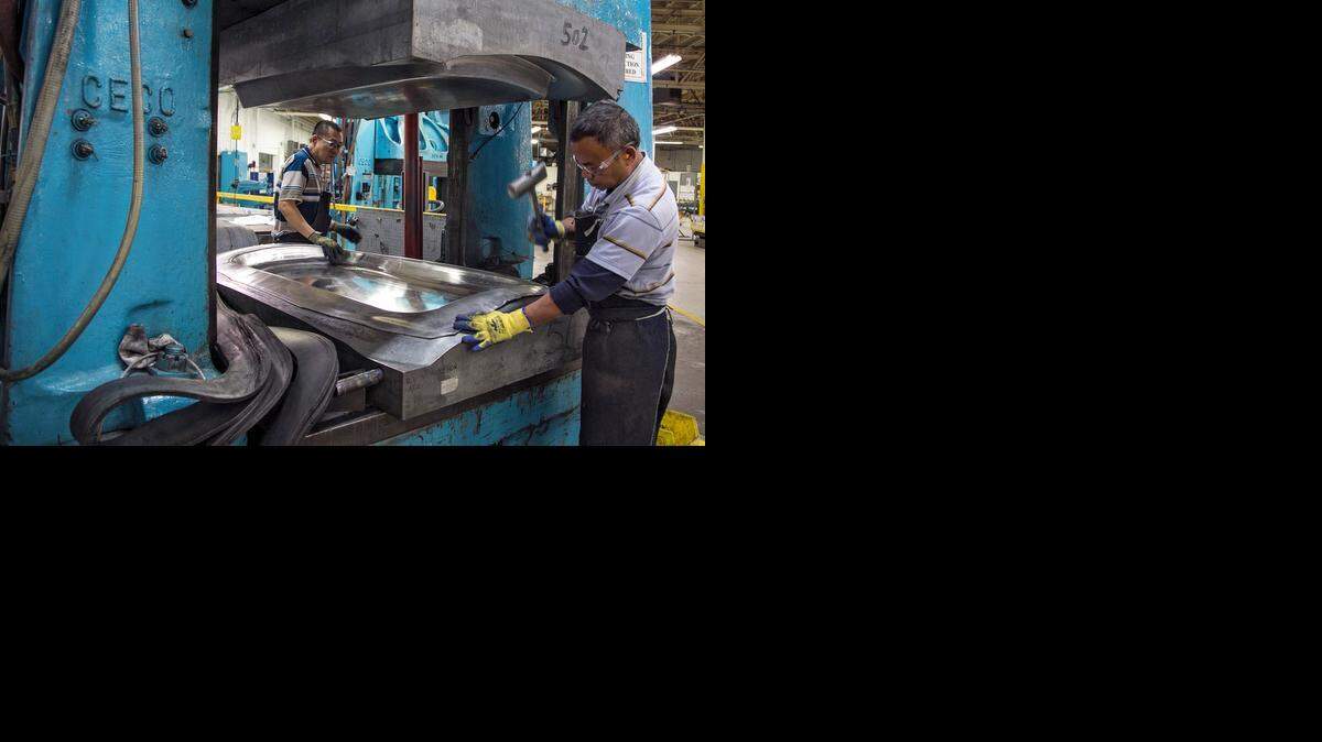 
Apex Engineering employees work on a B-52 escape hatch. Sedgwick County approved a forgiveable loan to help finance its expansion Wednesday.
