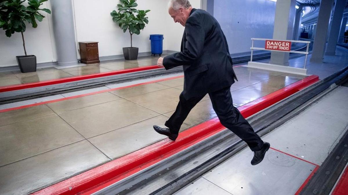 Sen. Jerry Moran, R-Kan. jumps the tracks of the Senate subway on Capitol Hill in Washington, Tuesday, July 18, 2017, to get around a large gathering of reporters as he arrives on Capitol Hill.