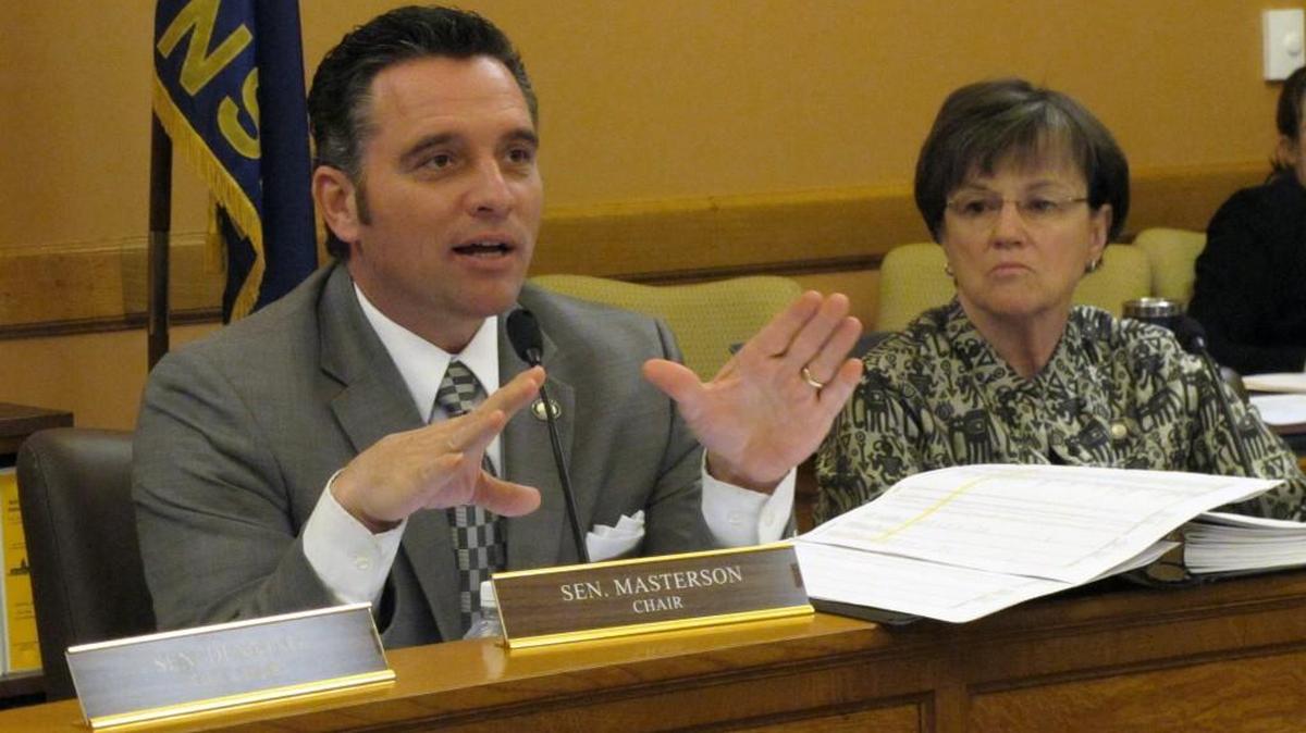 Kansas Senate Ways and Means Committee Chairman Ty Masterson, R-Andover, left, comments on school funding issues during a hearing on his plan to redistribute $39 million in state aid to help poor school districts on Wednesday.