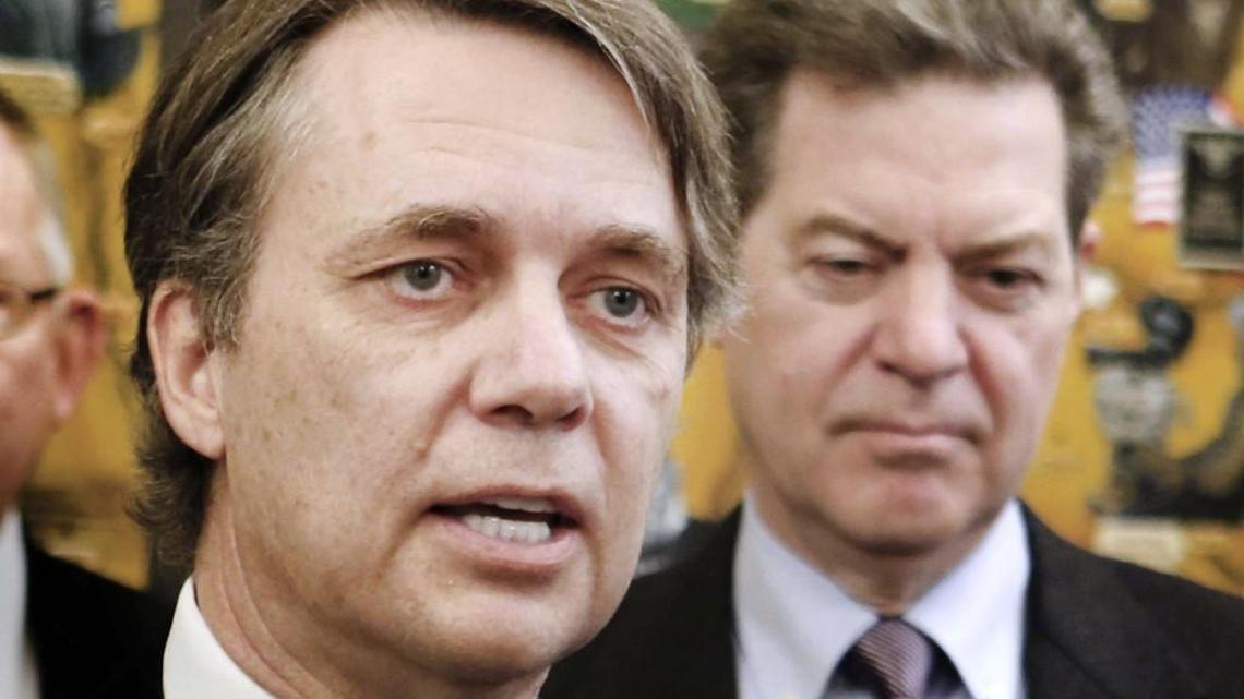 When  he was lieutenant governor, Jeff Colyer (left) helped lead efforts by then-Gov. Sam Brownback’s administration to create KanCare in 2013. An insurance company that missed out on a new contract to administer KanCare is formally protesting the state's decision.