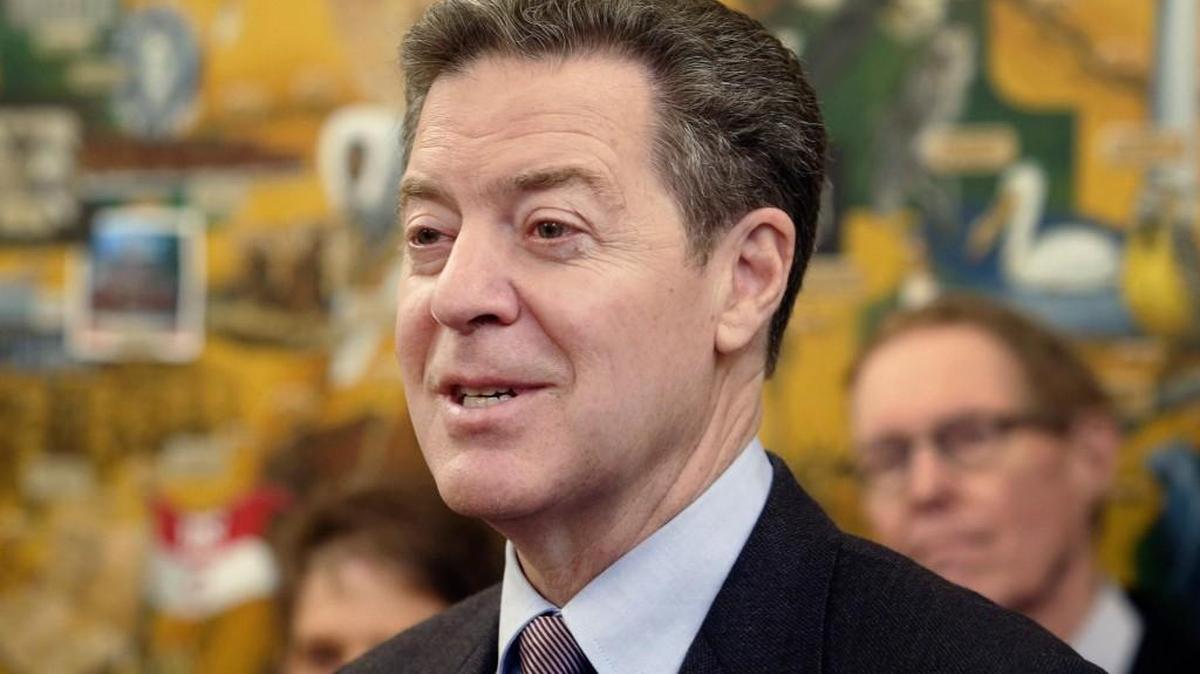 Kansas Gov. Sam Brownback speaks to media during a humanitarian award ceremony at the statehouse Thursday, March 9, 2017, in Topeka, Kansas.