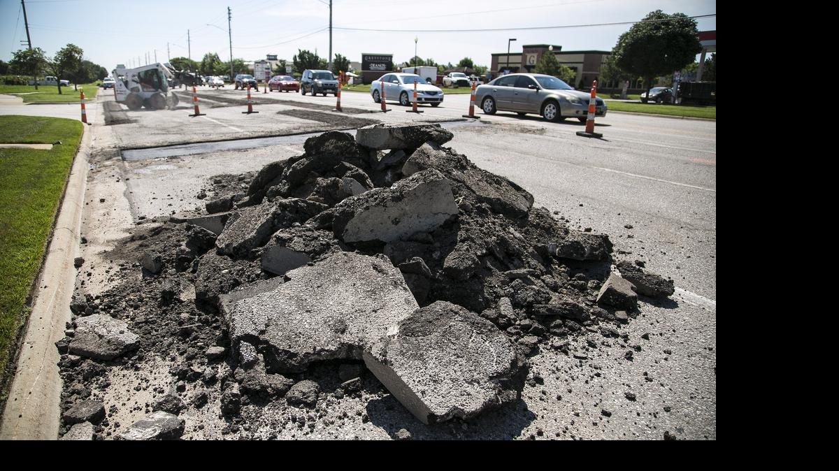 
Road construction on East 21st Street. Wichita drivers pay nearly $600 a year in vehicle operating costs as a result of driving on roads with “unacceptable ride quality,” according to a report from TRIP, a national nonprofit transportation research group. (July 23, 2015)

