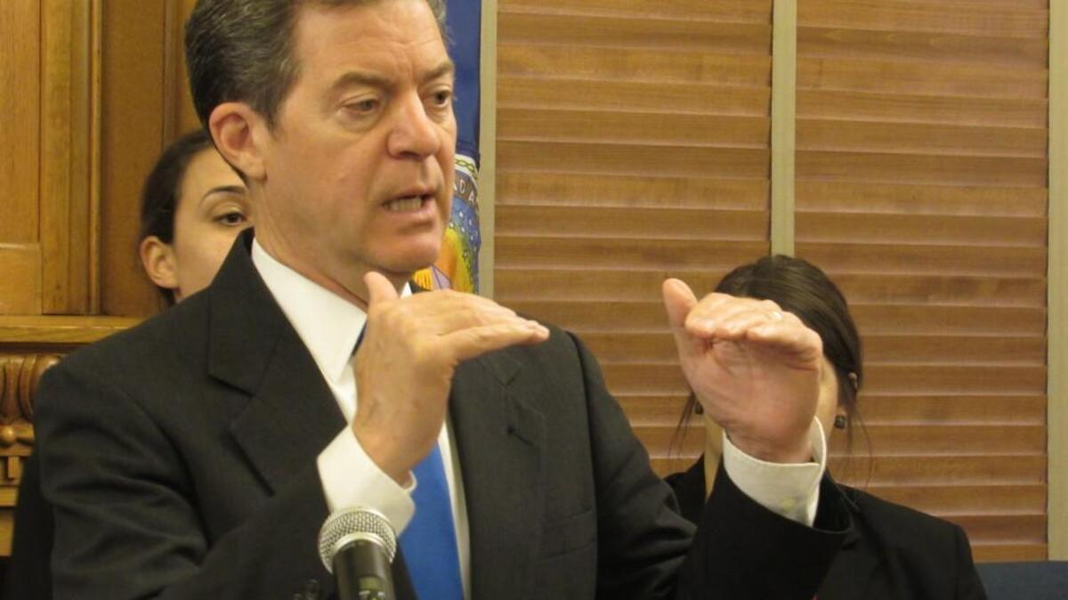 Gov. Sam Brownback said Wednesday that he will have to issue cuts to the state’s budget before he signs the budget bill narrowly passed by lawmakers last week.