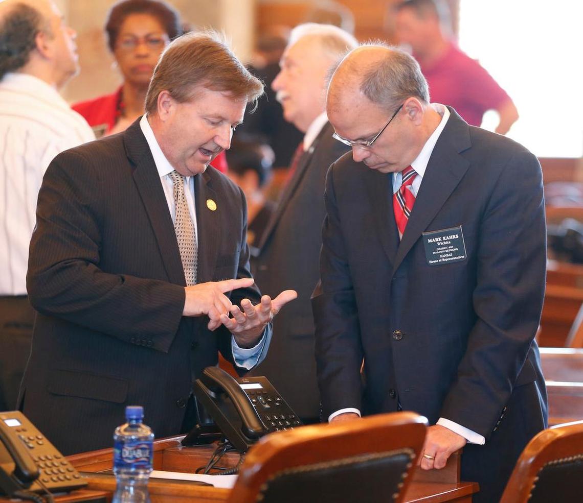 House Majority Leader Jene Vickrey, left, talks with Rep. Mark Kahrs R-Wichita, after the Kansas House recessed Wednesday morning. 