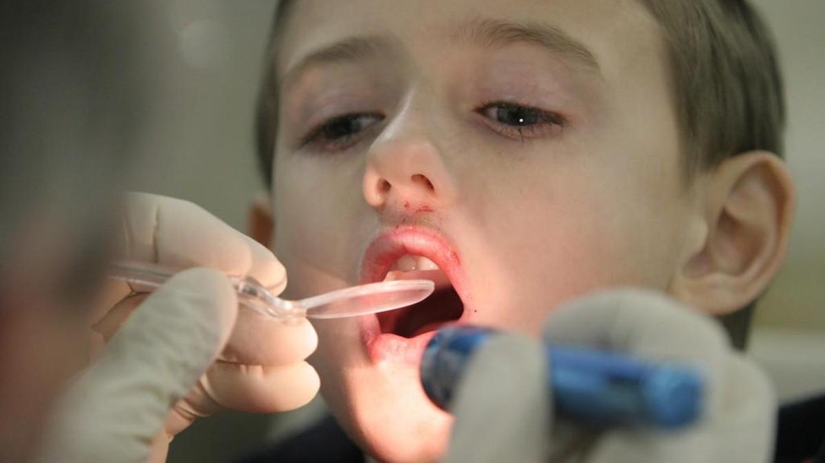 Jeremy Garrigus, 6, has his initial consultation with a dentist before he had two teeth pulled .