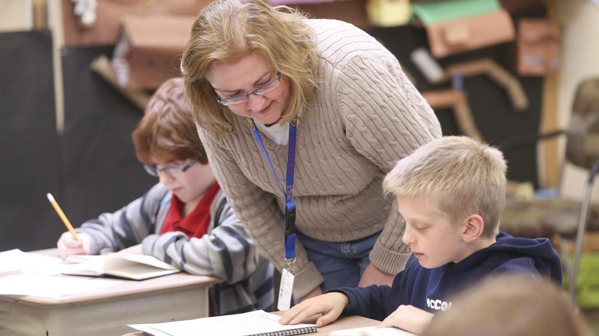McCollom Elementary teacher Amy Lockman works with Thatcher Auten in February.