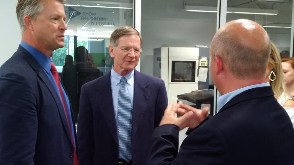 Rep. Lamar Smith, center, R-Texas and the House Science, Space and Technology Committee chairman, listens as Wichita State University vice president John Tomblin, right, outlines WSU research opportunities. Rep. Roger Marshall of Great Bend, left, brought Smith to Wichita in hopes of landing more air and space research work for Kansas.