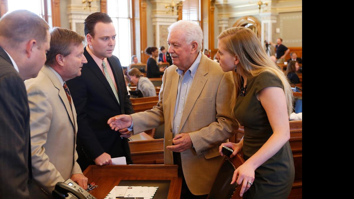 
Rep. Jene Vickrey, left center, House majority leader, , talks with Speaker of the House Ray Merrick, right, Monday afternoon on the floor of the House of Representatives. (June 8, 2015)
