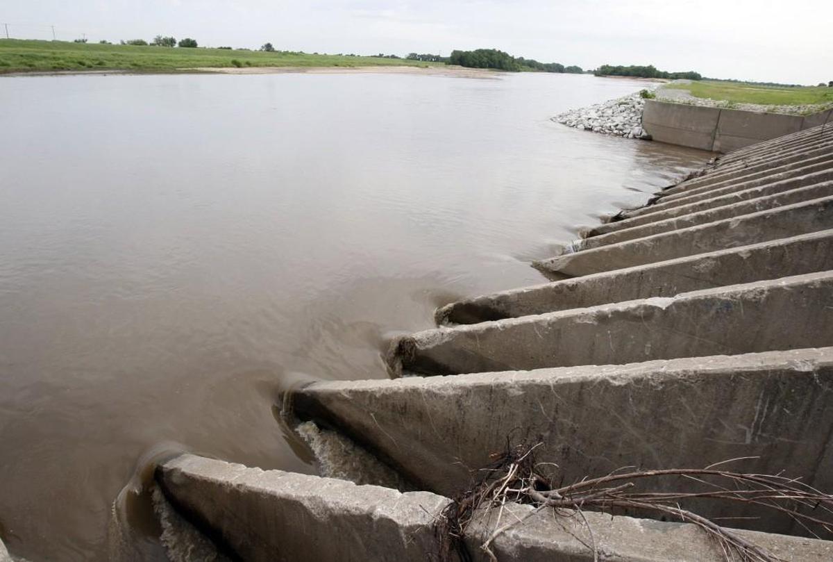 Water from the Arkansas River passes under the Big Ditch levee.