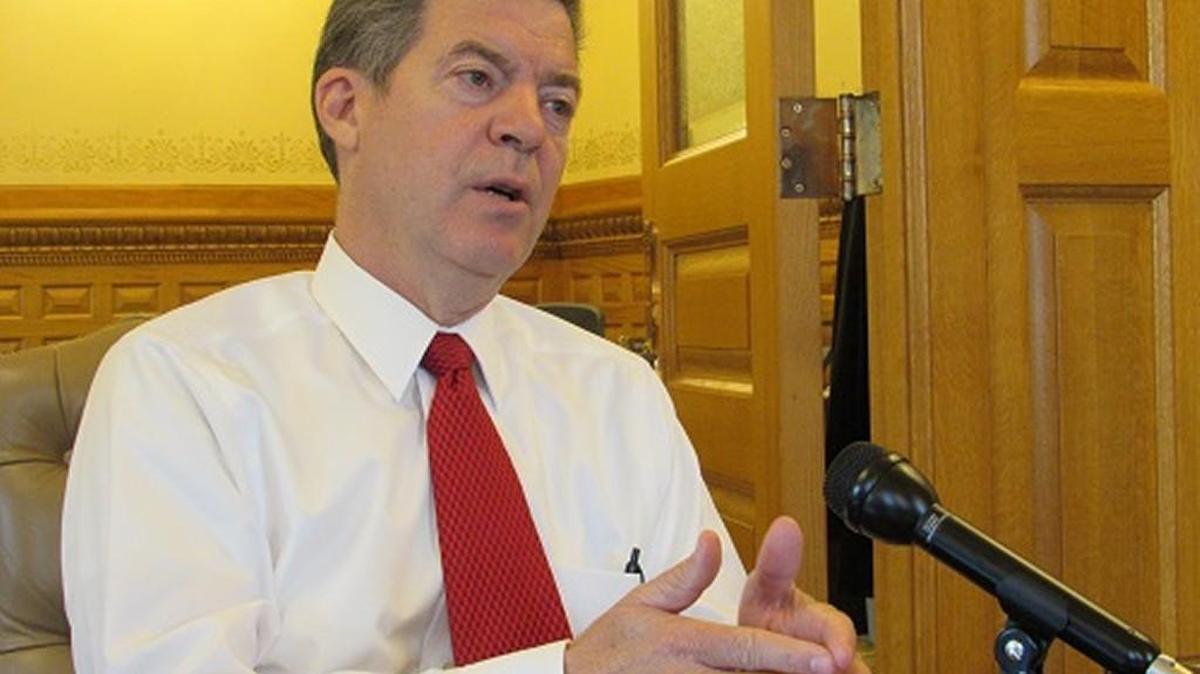 Kansas Gov. Sam Brownback meets with reporters in his office Friday.