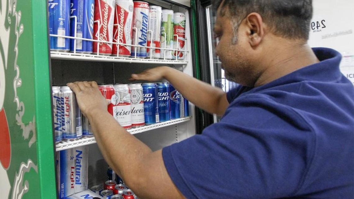 Moe’s Mart employee Faizul Bary stocks a cooler at the east Wichita minimart with 3.2 beer. Under a new law signed by Gov. Sam Brownback, Moe’s and other convenience and grocery stores will be able to sell stronger beer beginning in 2019. (March 16, 2016)