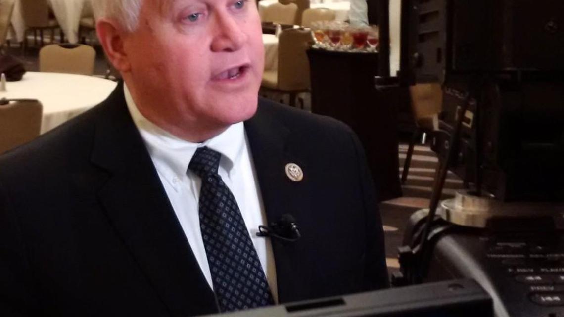 Rep. Ron Estes answers questions from reporters after a speech to Wichita Rotary Club members.