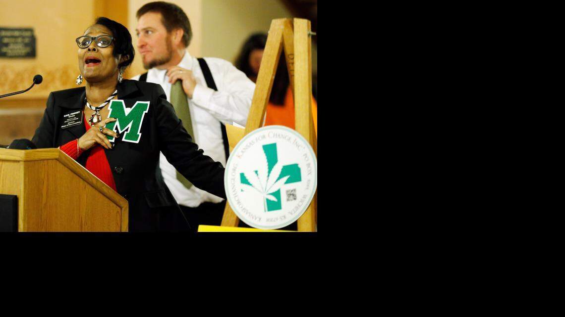 
Rep. Gail Finney, of Wichita displays a letter M (for marijuana) presented to her during a rally in the Kansas State House to legalize medical marijuana.
