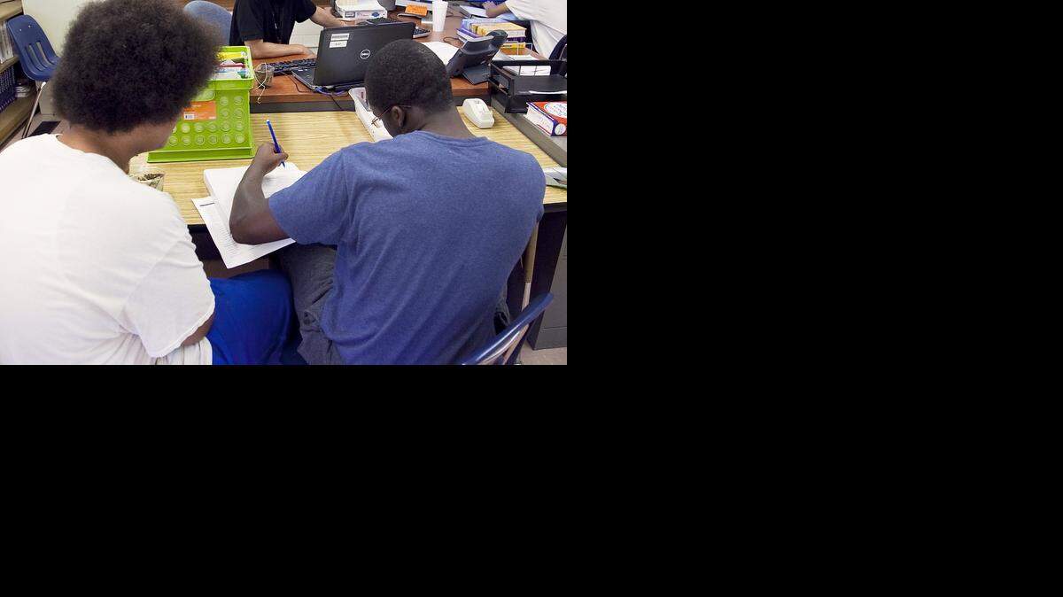 
Residents work on science homework at the Judge James V. Riddel Boys Ranch at Lake Afton in 2013.
