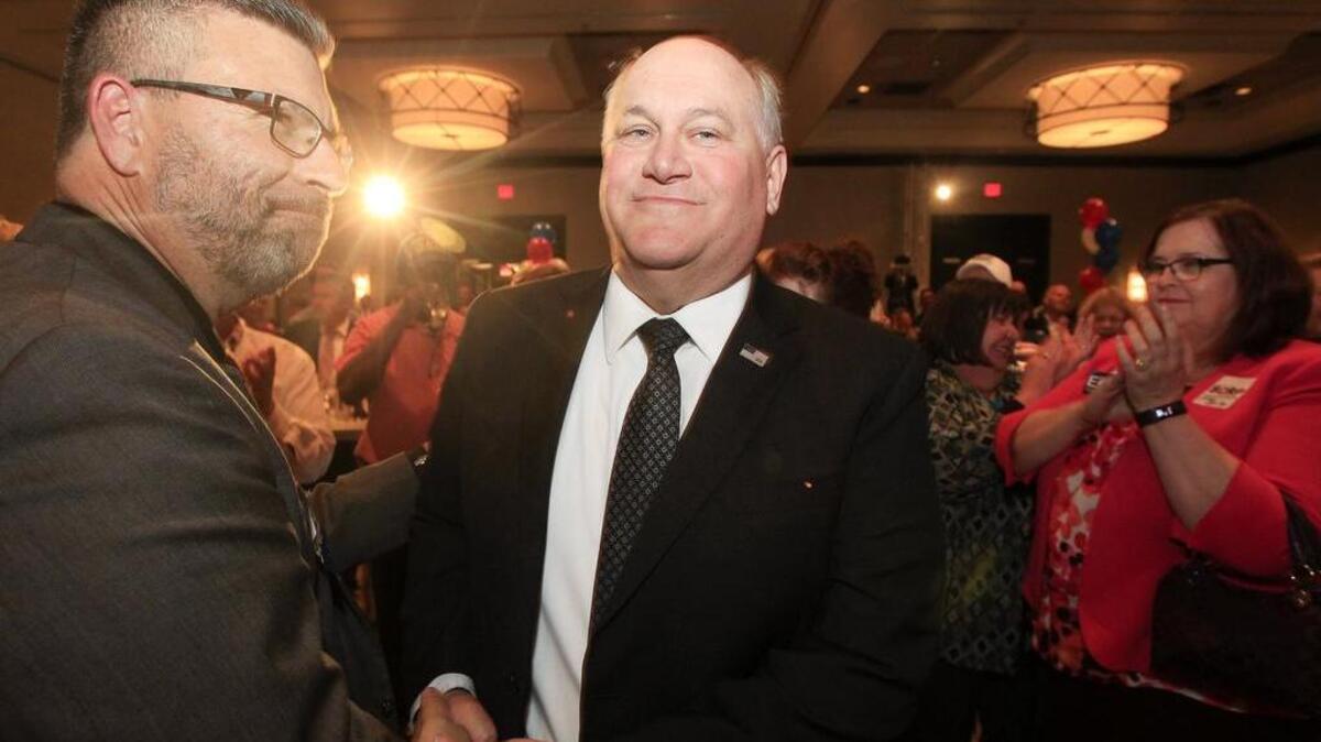 Republican Ron Estes, right, is congratulated after being named the winner of the 4th District congressional race in April.