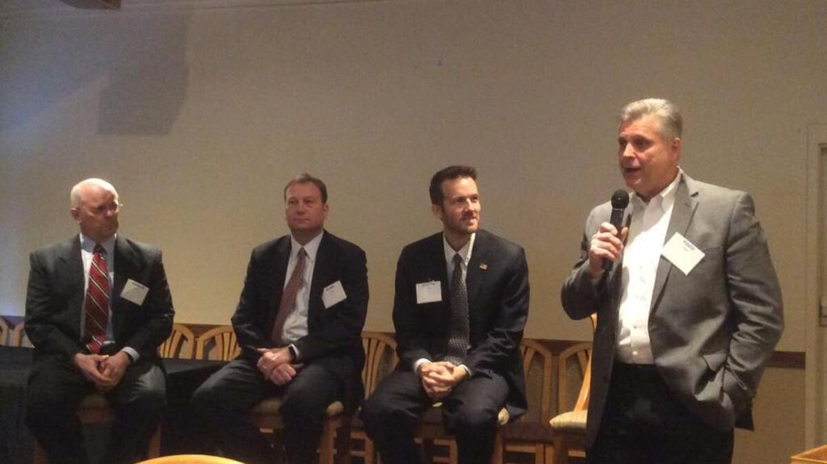 From left to right, George Bruce, Alan Cobb and Joseph Ashby listen to Todd Tiahrt at a forum Friday hosted by the Agri-Business Council of Wichita.