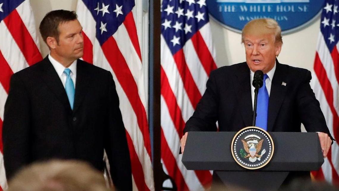 President Donald Trump, with Kansas Secretary of State Kris Kobach, speaks at a meeting of the Presidential Advisory Commission on Election Integrity on July 19, 2017, in the Eisenhower Executive Office Building on the White House complex in Washington.
