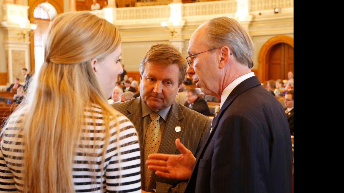 
House majority leader Representative Jene Vickrey (center left) talks with Kansas House Taxation Committee Chairman Marvin Kleeb, R-Overland Park before the house reconvened on Tuesday afternoon. Also pictured is Speaker’s Office communications director, Rachel Whitten.
