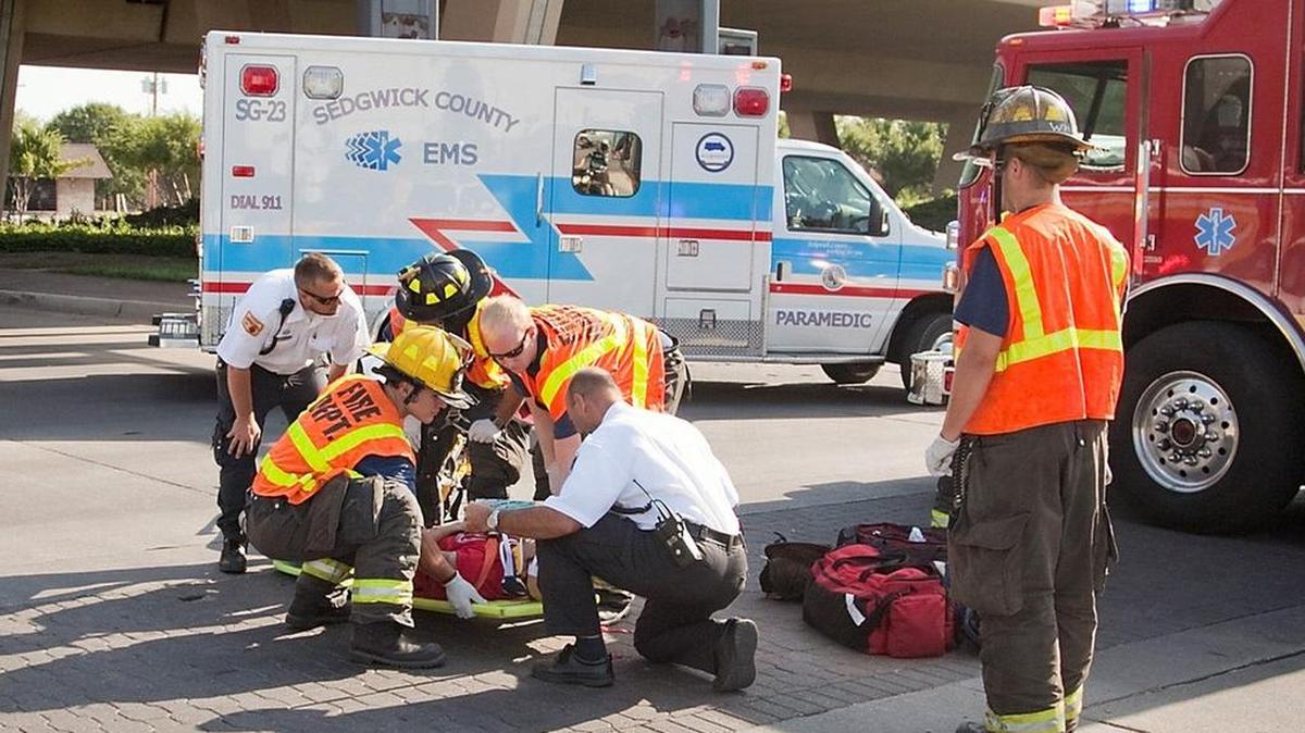 Firefighters and EMS personnel tend to an injured bicyclist in 2012. The Wichita City Council will consider a plan aimed at allowing private companies to provide non-emergency ambulance transport. Sedgwick County has been lobbying hard for them not to do that.