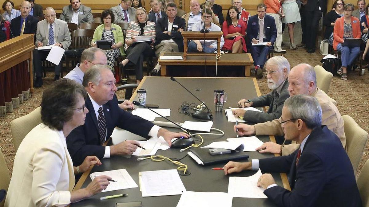 Senators and representatives discuss school finance in Topeka in early June.