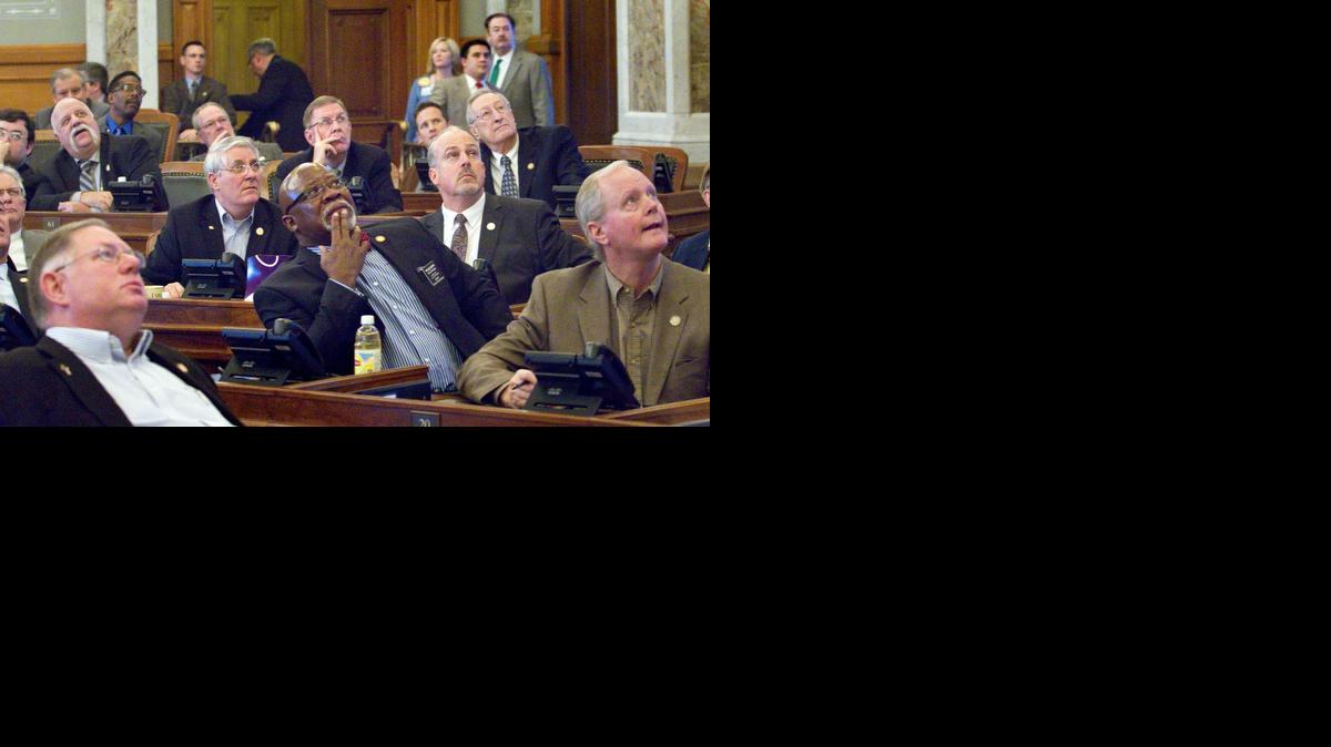 
Members of the House watch the vote board March 13 as votes were cast for a bill that would repeal the state’s school funding formula and replace it with a block grant system for the next two years. The bill later passed. 
