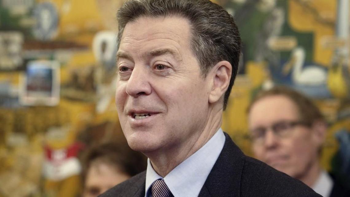 Kansas Gov. Sam Brownback speaks to media during a humanitarian award ceremony at the statehouse Thursday, March 9, 2017, in Topeka.