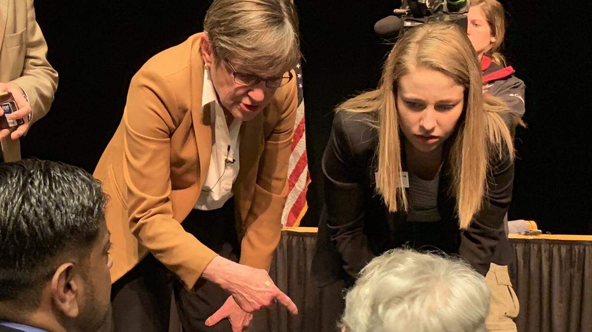 Gov. Laura Kelly speaks to audience members after a town hall at Johnson County Community College on Saturday.
