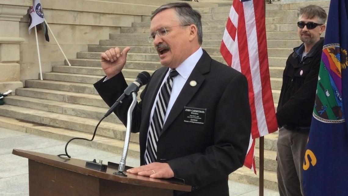 In a rally on the Capitol steps April 29, Rep. John Carmichael, D-Wichita, called supporters of a transgender bathroom bill “neanderthals.”